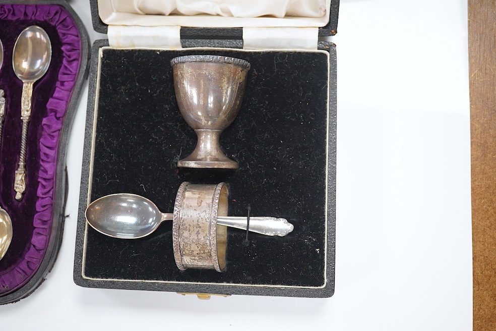 A cased set of six Victorian silver apostle teaspoons, tongs and caddy spoon, 1882, 3.7oz, and a cased George VI silver christening set comprising egg cup, napkin and spoon, 2.6oz. Condition - good.